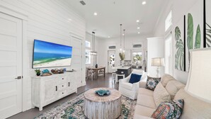 A spacious living room with a large flat-screen TV, a round coffee table, and a beige sofa. - BVR 67 - Kit Kamp by Liquid Life (Orange Beach)