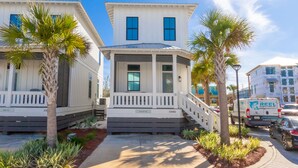 A two-story house with a porch and a small staircase leading to the entrance.