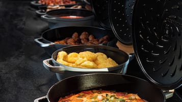 A buffet with various dishes including fried items, potatoes, and a casserole.