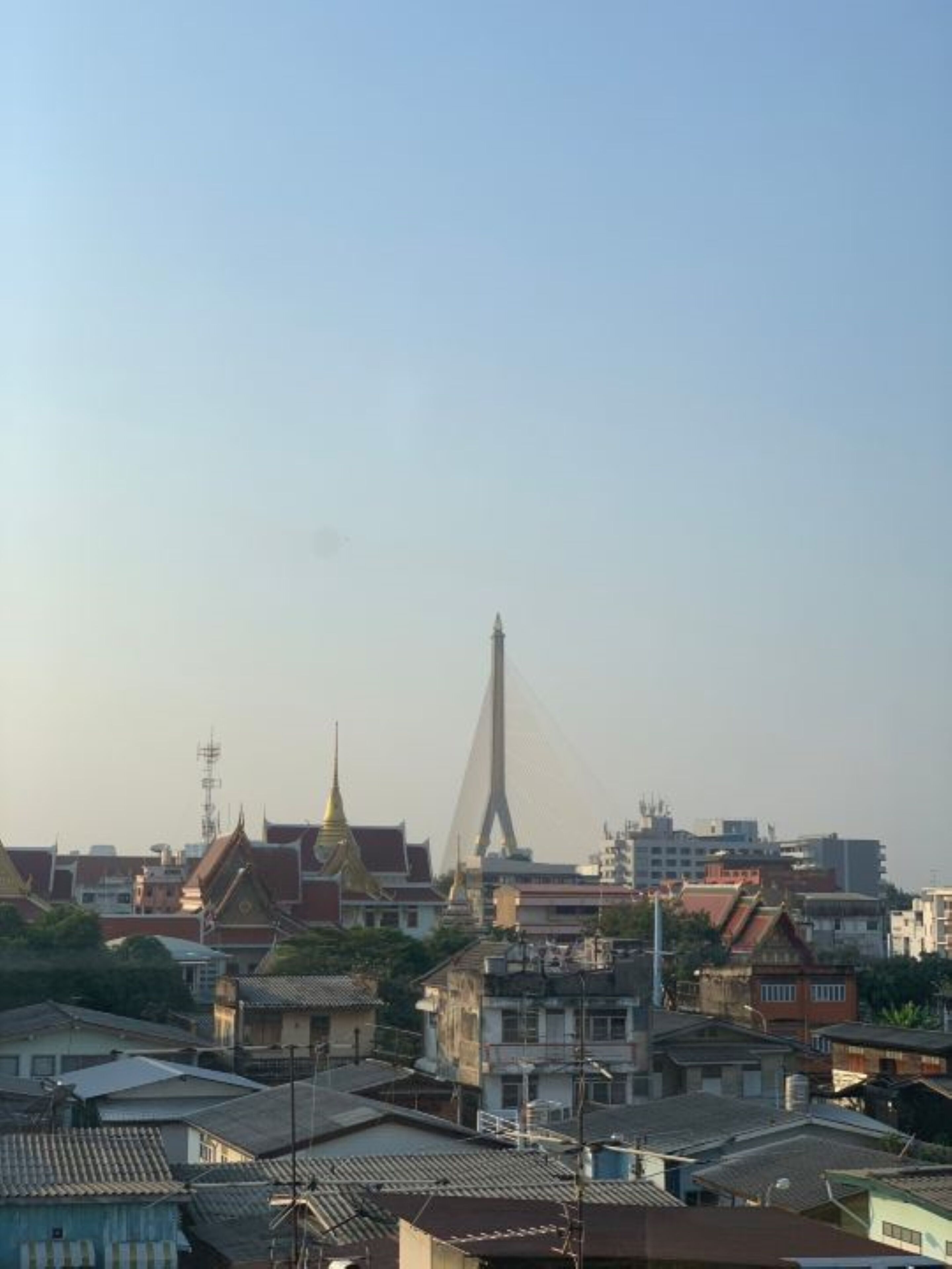 A cityscape with traditional buildings and a modern bridge.