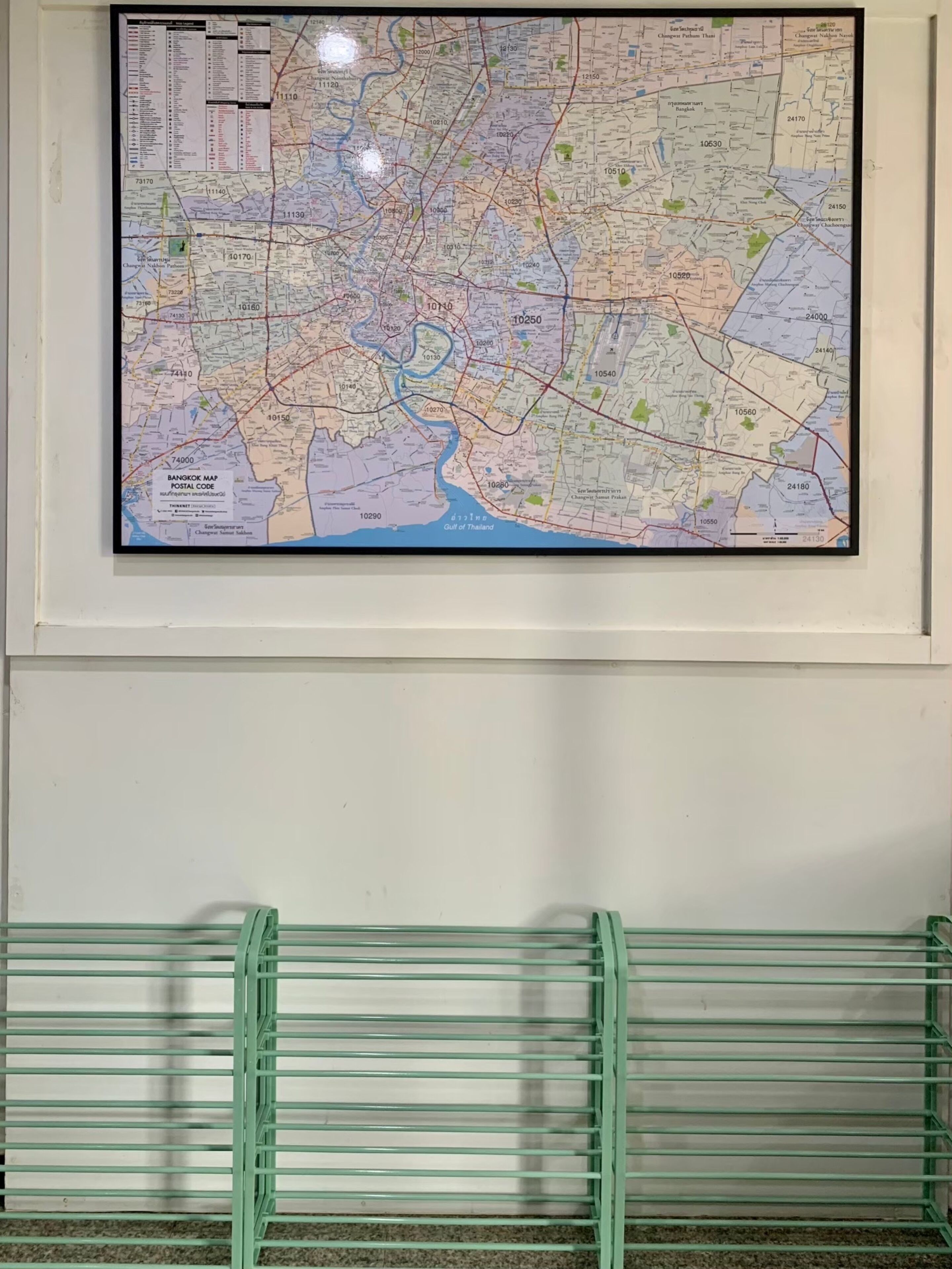 A framed Bangkok map with postal codes.