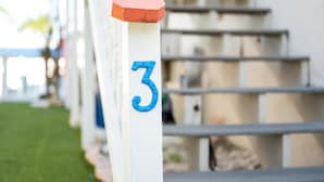 A white post with a blue number '3' and a red roof. - LJ's Cottages 3 - BALCONY BEACH POOL SAND SUNSETS (Sarasota)