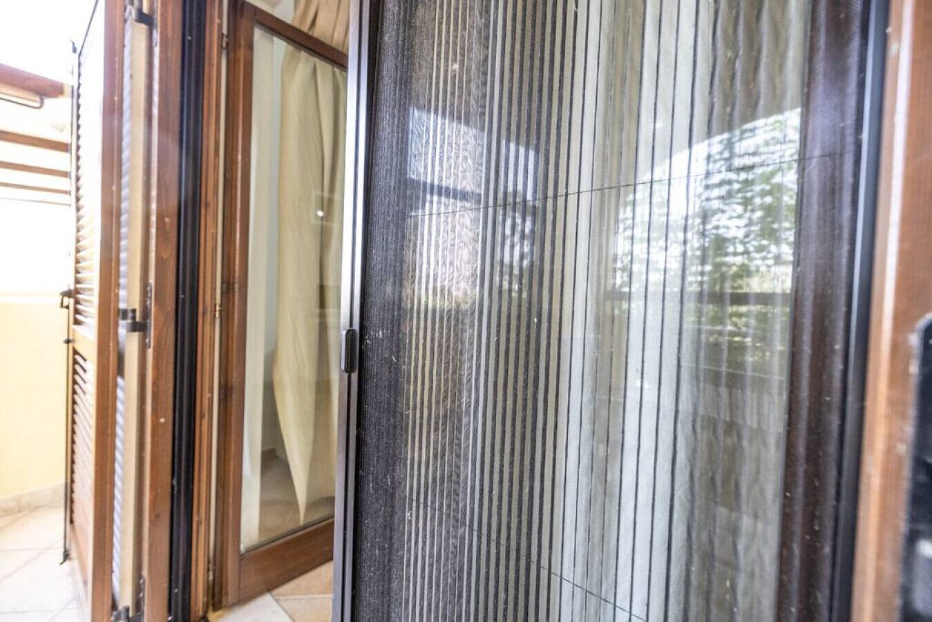 A sliding glass door with a view of a residential area.