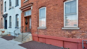 A row of brick buildings with large windows and a fire escape. - Uncle Sam's Hideaway |Nearby Colleges & Hospital|Personal Workspace|Pet Friendly (Troy)