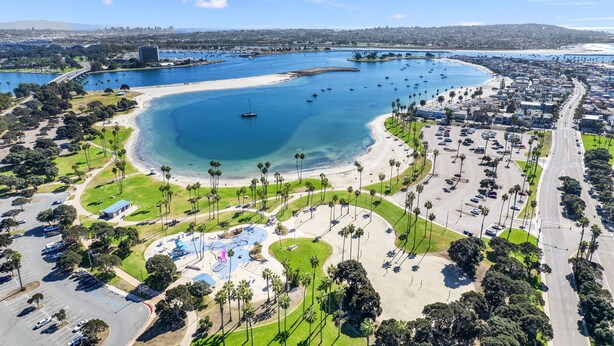 An aerial view of a coastal area with a large marina, sandy beaches, and a parking lot. - Gorgeous Beach Villa -- Ocean Views + Sleeps 12! (San Diego)
