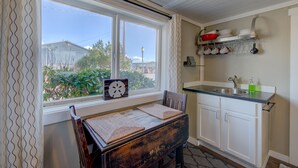 A kitchen with a window, a table, and a counter. - The Akari Bungalow #5 (Long Beach)