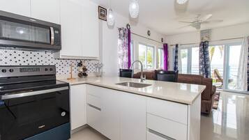 A modern kitchen with a built-in oven, microwave, and sink.