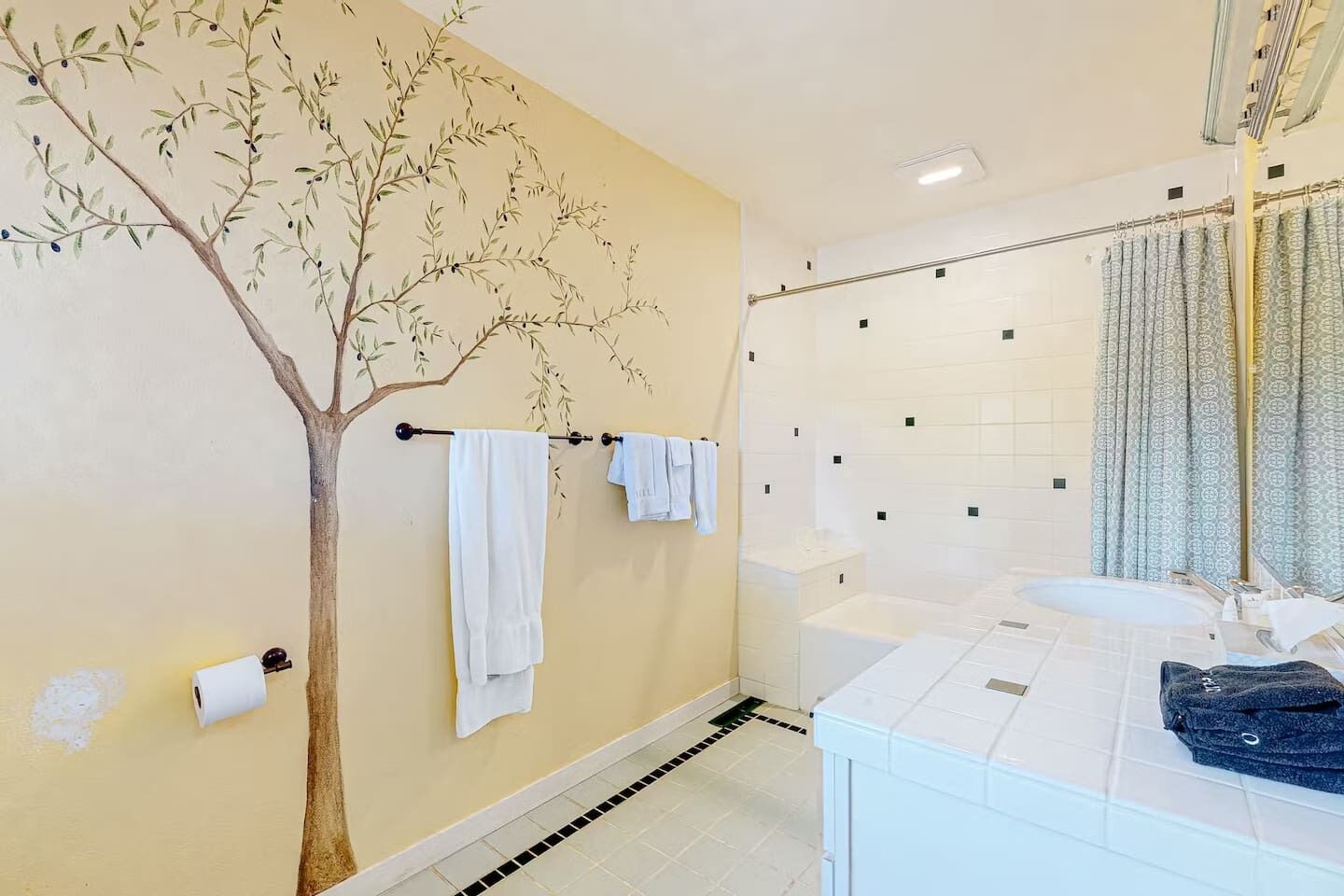 One-of-a-kind bathroom featuring a stunning hand-painted olive tree mural — pure artistry meets everyday luxury. Tub, shower & vanity all wrapped in warm Sonoma charm. 🌿🛁✨