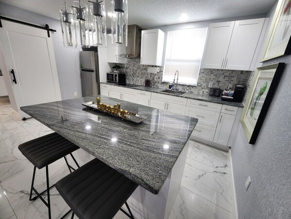 Fridge, microwave, stovetop, coffee/tea maker