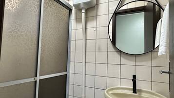 Ein Badezimmer mit Toilette, Waschbecken, Spiegel und Handtuchhalter.