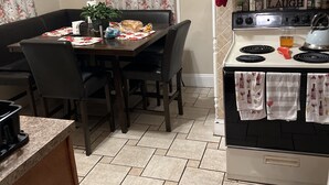 A cozy kitchen with a dining table, chairs, a stove, and a sign that says "Live Love Laugh." - Historical section of Chesapeake. Propertie nice and groomed quiet neighborhood. (Chesapeake)
