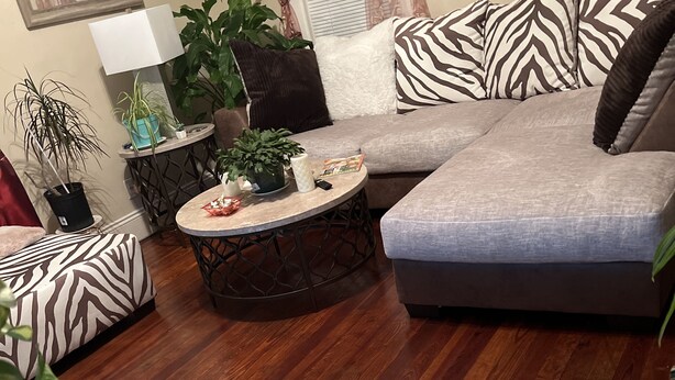 A living room with a grey sectional sofa, a round coffee table, and various decorative pillows. - Historical section of Chesapeake. Propertie nice and groomed quiet neighborhood. (Chesapeake)