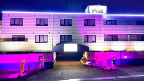A hotel with a modern facade, multiple windows, and a sign indicating it is a hotel.
