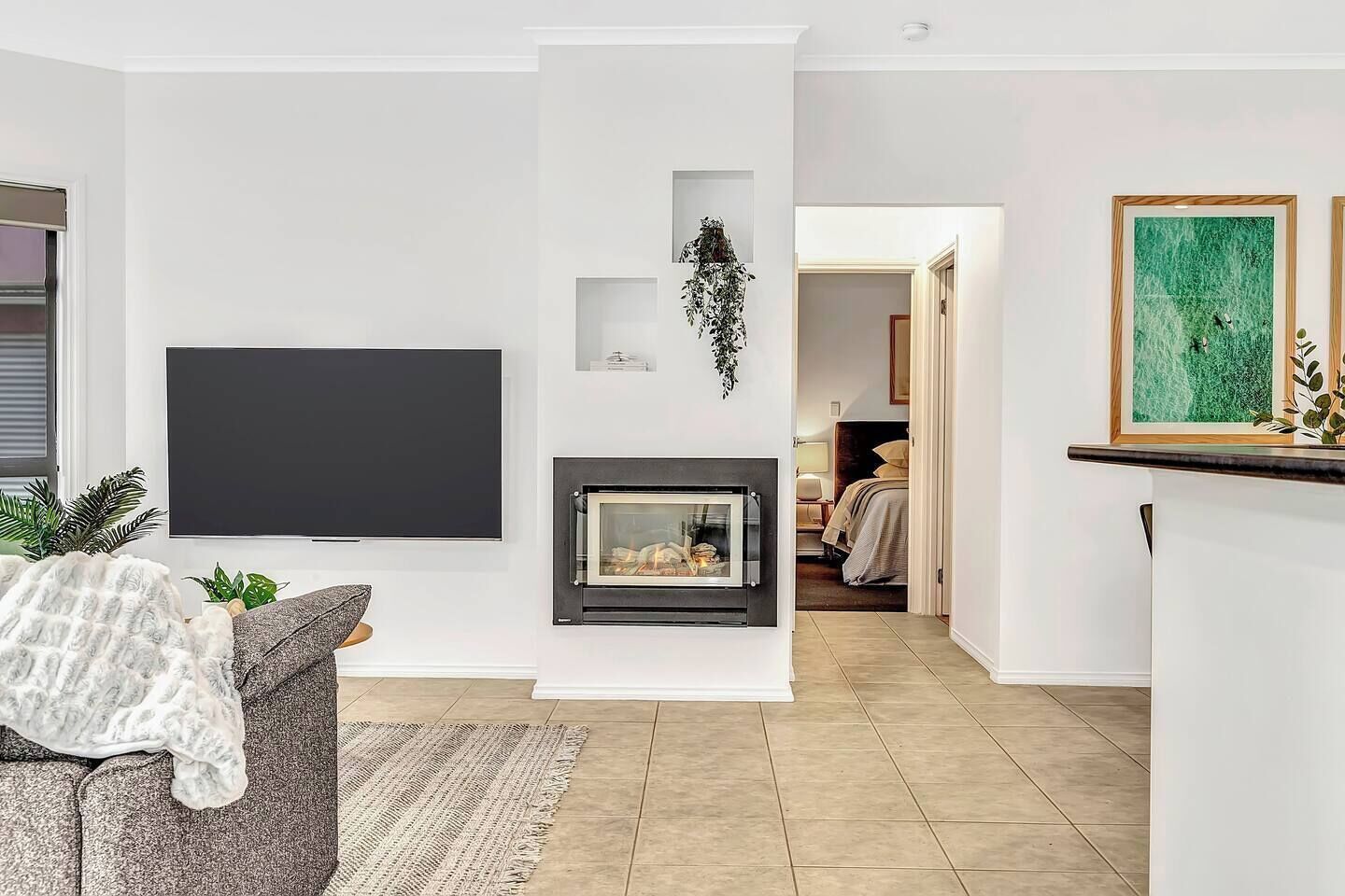 Stay cosy within the plush living room with a gas fireplace and flat-screen TV.