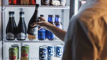 A refrigerator stocked with various beverages including bottles and cans.