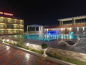 A swimming pool at night with a building labeled "Mini Resort" in the background. - Shinjini Resort (Kanthi)