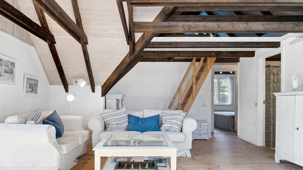 A loft-style living room with exposed wooden beams, white furniture, and a glass coffee table. - "Emanuela" - 800m from the sea by Interhome (Gilleleje)