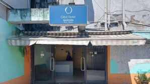 The exterior of Orbit Hotel on the 3rd floor with a signboard, glass doors, and a small entrance area. - Orbit Hotel Bagdogra (Siliguri)