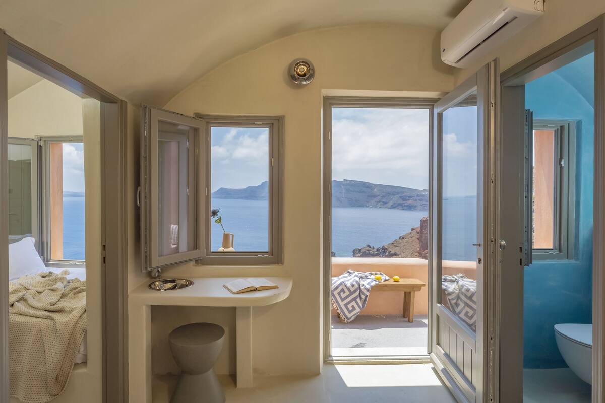 Une salle de bain avec vue sur la mer, un lavabo et des toilettes.