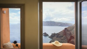 A room with a view of a coastal landscape, including cliffs and the sea. - Oia Waves by SV (Santorini)
