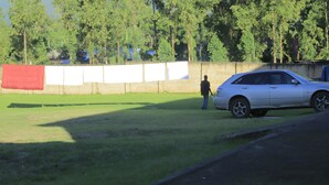 A parking area with a car and a person standing near it. - Rainbow hotel-annex (Bundibugyo)