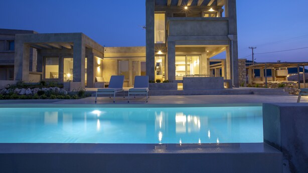 A modern building with a pool and outdoor seating. - Villa Kymo by Thines Villas (Lefkada)