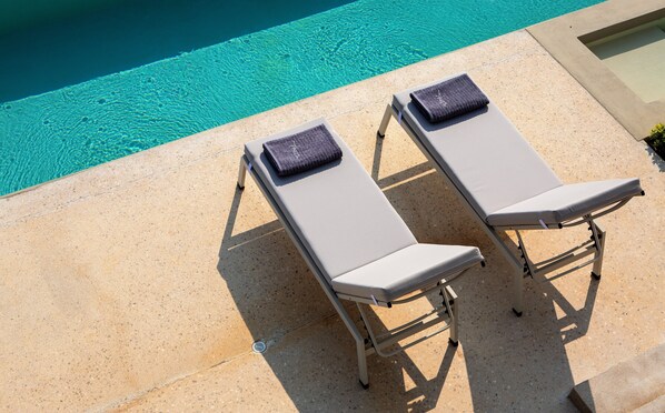 Two sun loungers with towels beside a pool. - Villa Kymo by Thines Villas (Lefkada)
