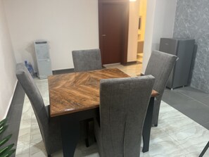 Enjoy meals in this stylish dining area with a rectangular table and four comfortable chairs.