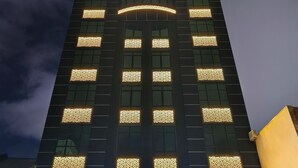 A modern hotel building with a prominent 'Zoom Hotel' sign at the top. - ZOOM HOTEL (George Town)