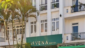 A multi-story hotel with a prominent green sign reading 'SEVEN A HOTEL'. - Seven A Hotel (Xuan Huong - Da Lat)