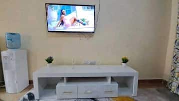 Deluxe Apartment | Living area | 24-inch Smart TV with digital channels