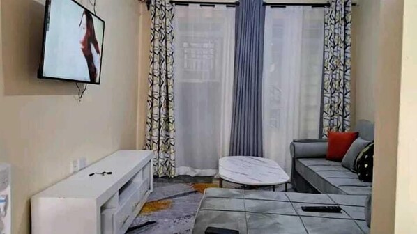 Deluxe Apartment | Living area | 24-inch Smart TV with digital channels