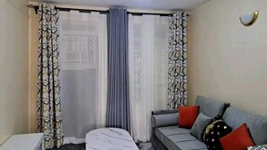 Deluxe Apartment | Living area | 24-inch Smart TV with digital channels - Lux Suites Lumumba Drive Apartments (Nairobi)