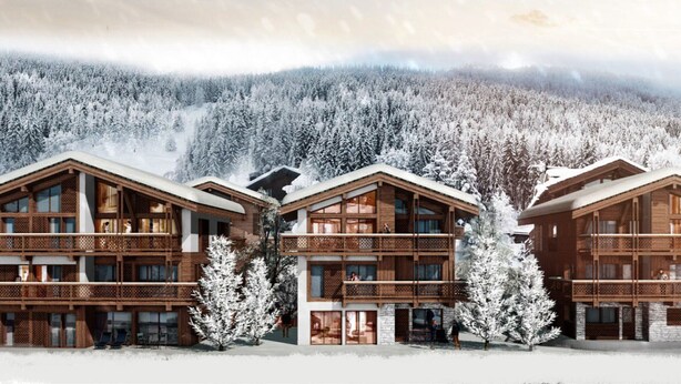 A modern wooden lodge with multiple balconies and large windows, surrounded by a snowy forest.