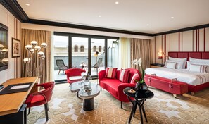 Relax in a stylish room with a large bed, sofa, and city view.