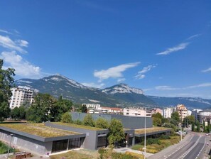 Set against a stunning mountain backdrop, this building offers a contemporary design with expansive windows.
