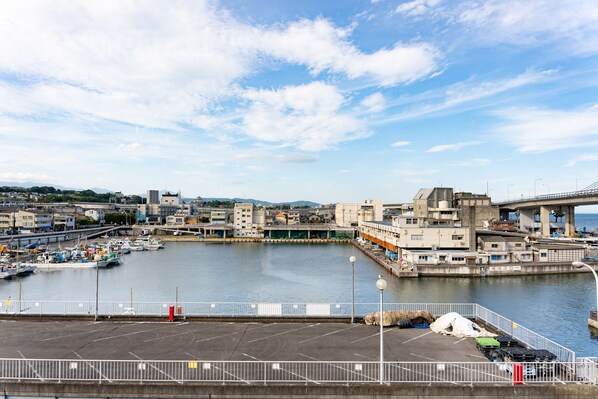 A harbor with boats, a bridge, and buildings. - Shio no Kaori (Odawara)