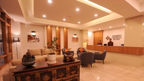 A hotel lobby with a reception desk, seating area, and decorative elements. - Thimphu Central Hotel (Thimphu)