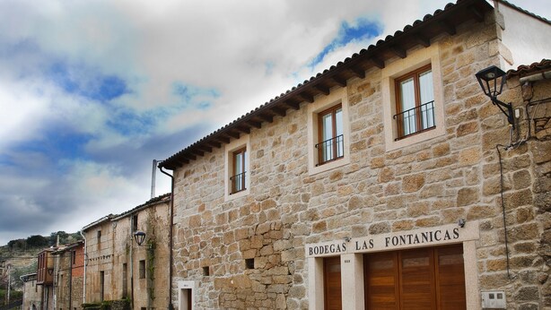 A stone building with a sign reading "BODEGAS LAS FONTANICAS". - La Casa del Vino (Fermoselle)