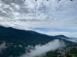 A mountainous landscape with a village at the base.