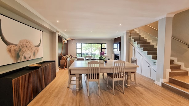 A modern interior with a dining area, a staircase, and a large window. - Pearl Valley Golf Lodge - Loadshedding f (Paarl)