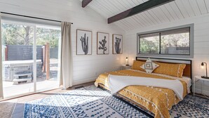 A bedroom with a large bed, a ceiling fan, a window with blinds, and a view of the outdoors. - Stunning 3 bedroom Sedona Home (Sedona)