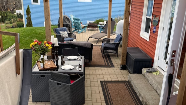 A patio area with outdoor furniture, a hot tub, and a view of the backyard. - Relax on the South Shore, steps from 2 beaches, ocean views & hot tub. (East River Point)