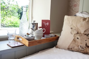 A tray with a glass pitcher, cups, and a box on a window sill. - The Plough Inn (Lechlade)
