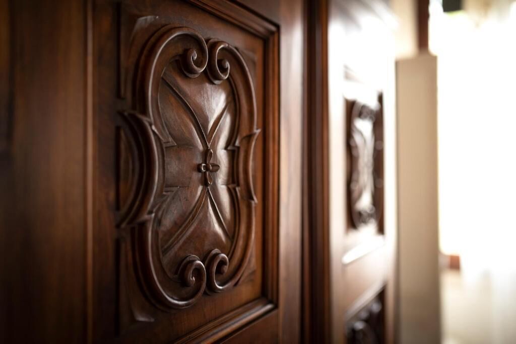 A close-up of a wooden door with intricate carvings.