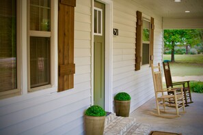 A porch with a wooden rocking chair, a door, and a mailbox. - Relax Near the Lake less than 2 miles from JP Coleman State Park (Iuka)