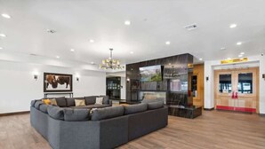 A modern living room with a sectional sofa, a flat-screen TV, and a fireplace. - The Southwestern Park City Mountain Resort Condo (Park City)