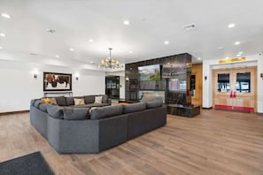 A modern living room with a sectional sofa, a flat-screen TV, and a fireplace. - The Southwestern Park City Mountain Resort Condo (Park City)