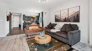 A modern living room with a sofa, coffee table, and a painting on the wall. - The Southwestern Park City Mountain Resort Condo (Park City)