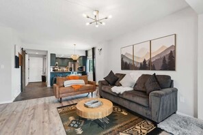 A modern living room with a sofa, coffee table, and a painting on the wall. - The Southwestern Park City Mountain Resort Condo (Park City)